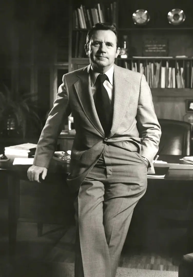 Leslie Lampton Sr. leaning on his office desk